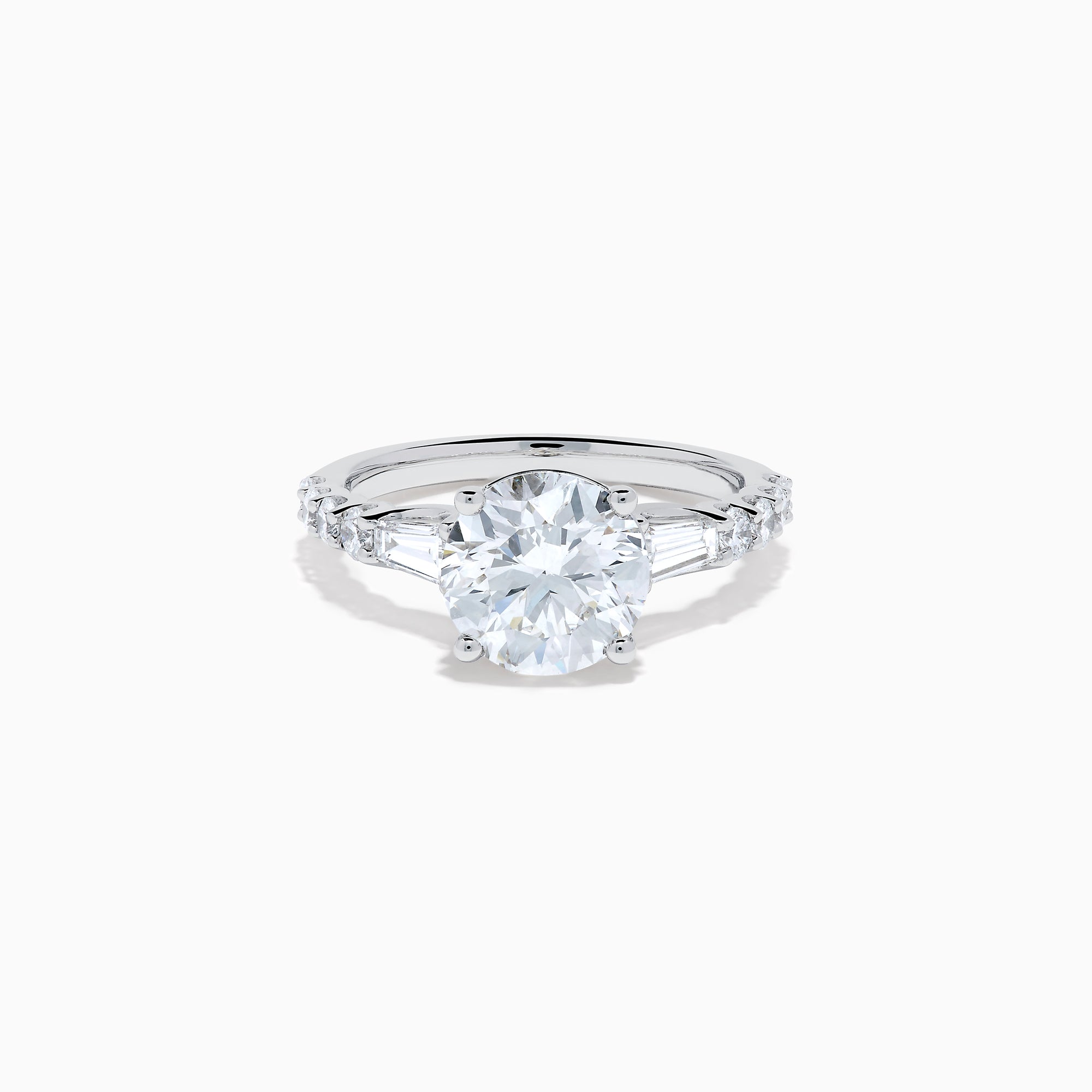 The Star Lab Grown Diamond Ring in 18K White Gold showcases a large oval-cut center stone with baguette and round accents along the band, elegantly presented on a white background.