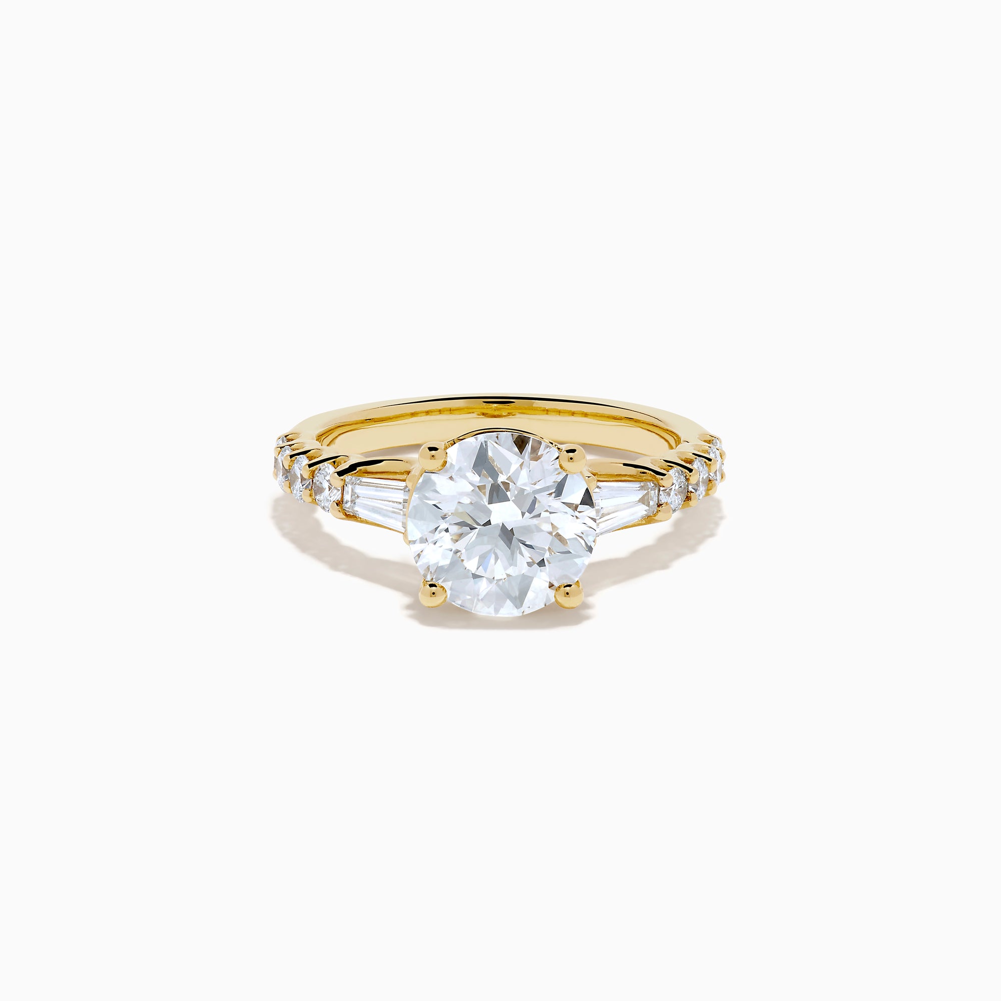 The Star Lab Grown Diamond Ring in 18K Yellow Gold showcases a large oval-cut lab diamond center stone with smaller rectangular accents along the band, elegantly displayed on a plain white background.