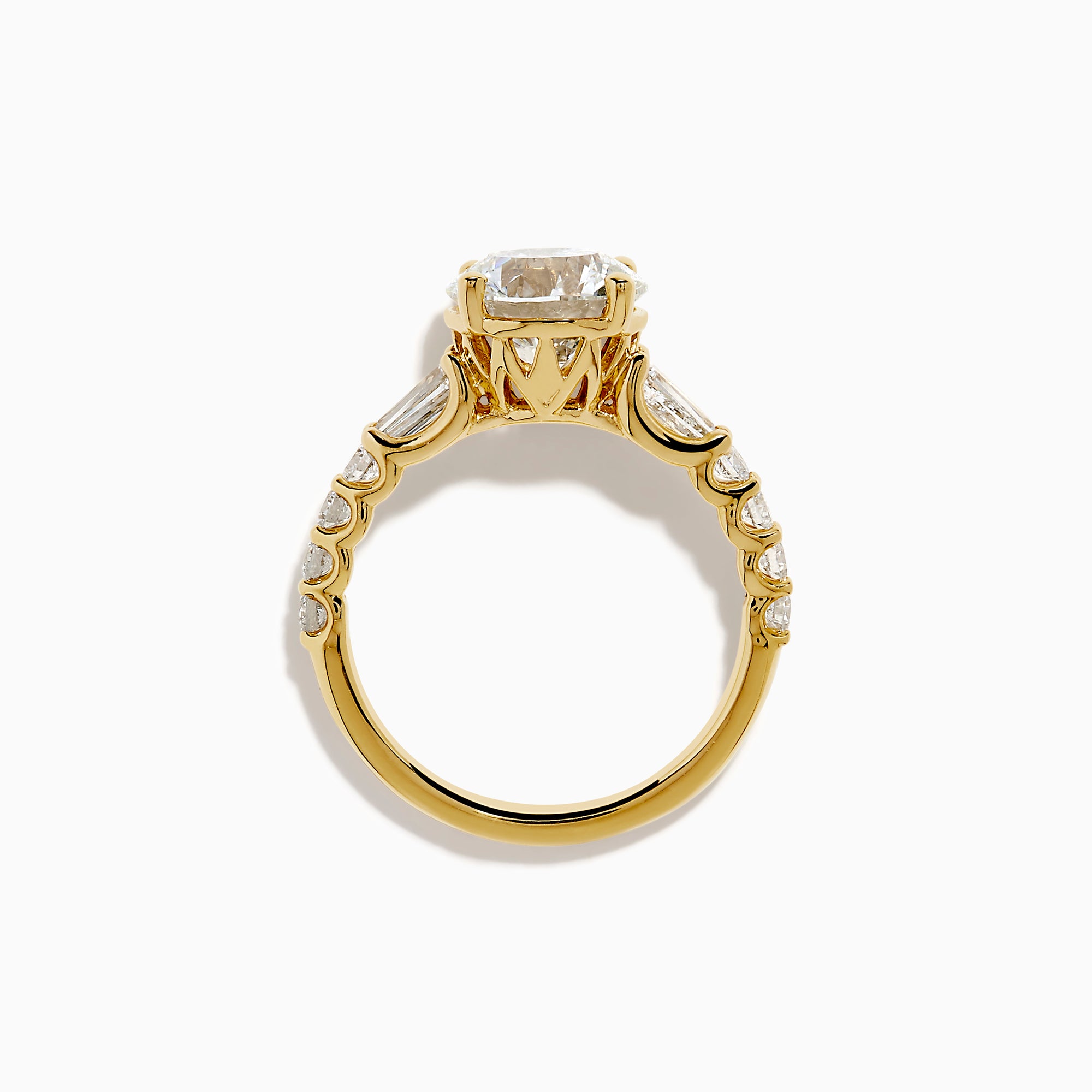 The Star Lab Grown Diamond Ring in 18K Yellow Gold showcases a large oval-cut lab diamond center stone with smaller rectangular accents along the band, elegantly displayed on a plain white background.