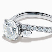 The Star Lab Grown Diamond Vine Ring in 18K White Gold features a large round lab-grown diamond center, accented with smaller diamonds along the band and an elegant vine twist design—an exquisite statement piece.