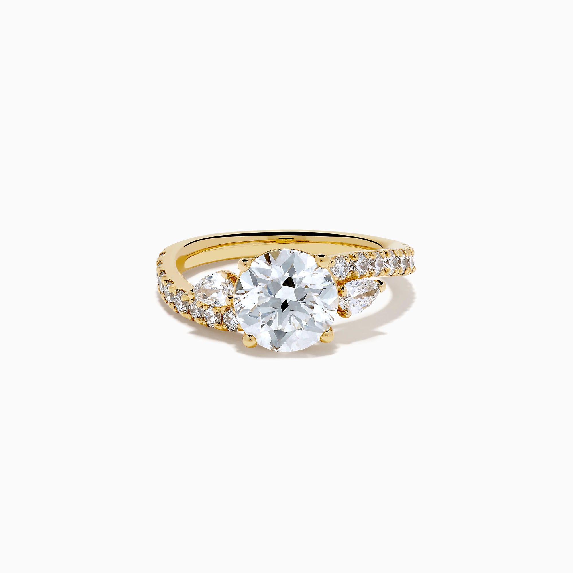 The Star Lab Grown Diamond Vine Ring in 18K Yellow Gold features a large round lab diamond and smaller diamonds along a split shank, beautifully displayed against a white background.