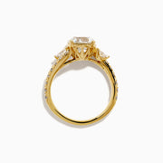 The Star Lab Grown Diamond Vine Ring in 18K Yellow Gold features a large round lab diamond and smaller diamonds along a split shank, beautifully displayed against a white background.