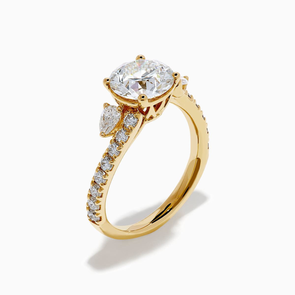 The Star Lab Grown Diamond Vine Ring in 18K Yellow Gold features a large round lab diamond and smaller diamonds along a split shank, beautifully displayed against a white background.