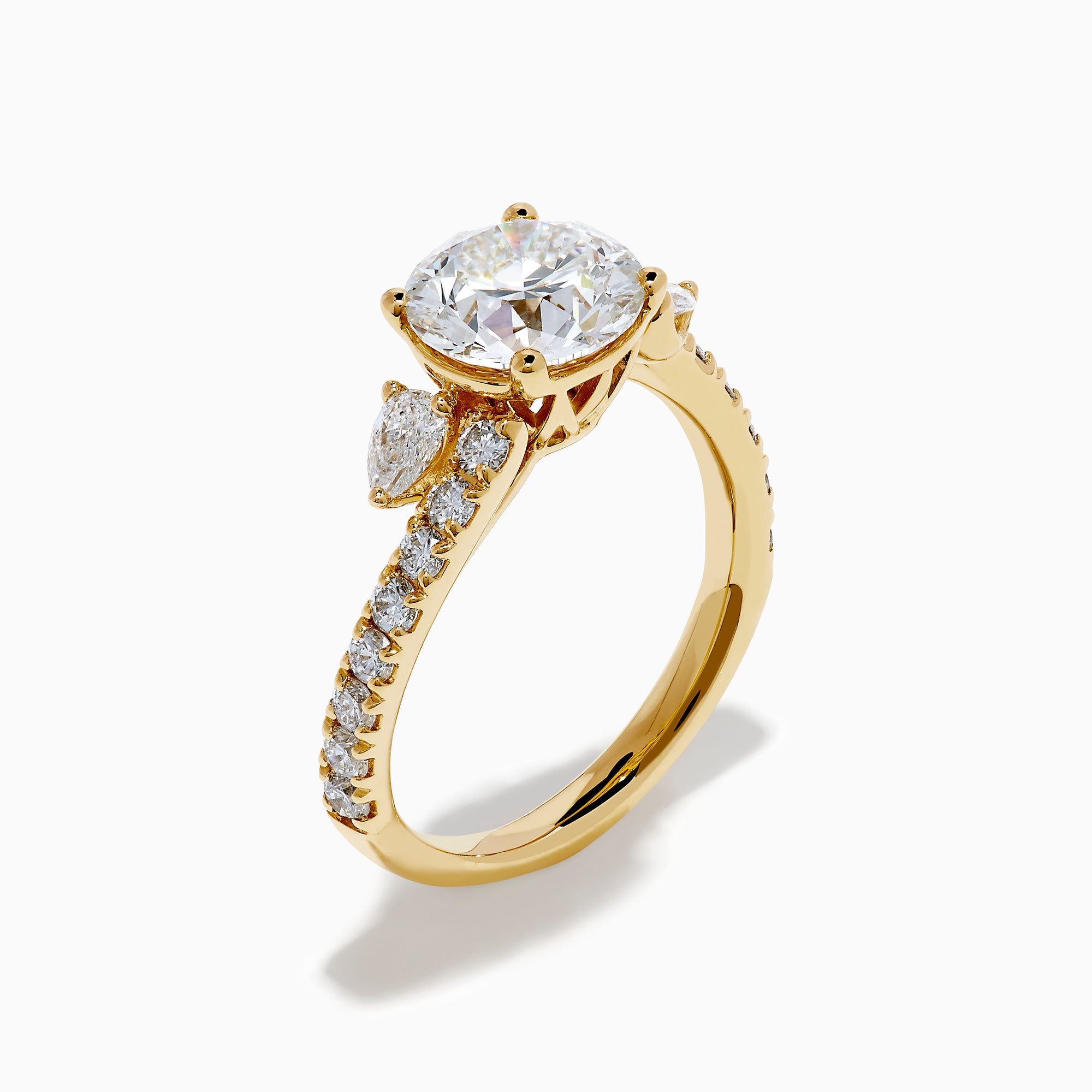 The Star Lab Grown Diamond Vine Ring in 18K Yellow Gold features a large round lab diamond and smaller diamonds along a split shank, beautifully displayed against a white background.