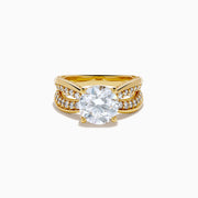 The Star Lab Grown Diamond Embrace Ring in 18K Yellow Gold showcases a prominent round lab-grown diamond center, with rows of smaller diamonds along the band and detailed side designs.