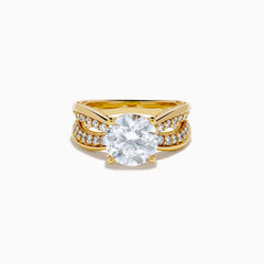 The Star Lab Grown Diamond Embrace Ring in 18K Yellow Gold showcases a prominent round lab-grown diamond center, with rows of smaller diamonds along the band and detailed side designs.