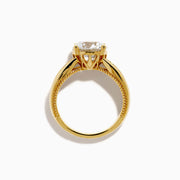 The Star Lab Grown Diamond Embrace Ring in 18K Yellow Gold showcases a prominent round lab-grown diamond center, with rows of smaller diamonds along the band and detailed side designs.