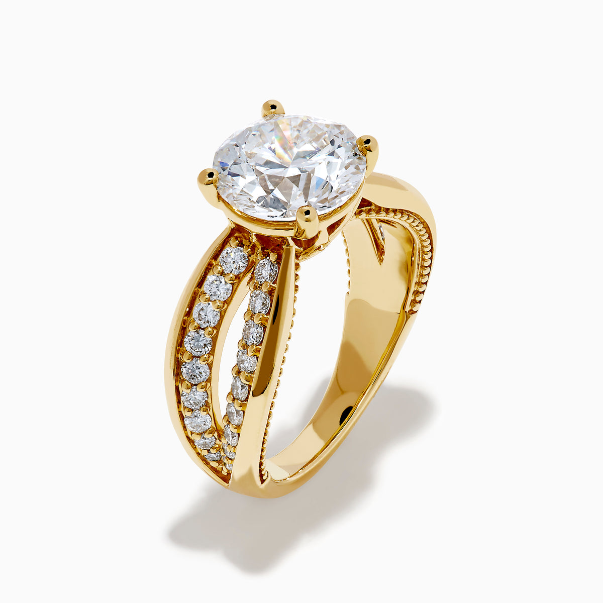 The Star Lab Grown Diamond Embrace Ring in 18K Yellow Gold showcases a prominent round lab-grown diamond center, with rows of smaller diamonds along the band and detailed side designs.