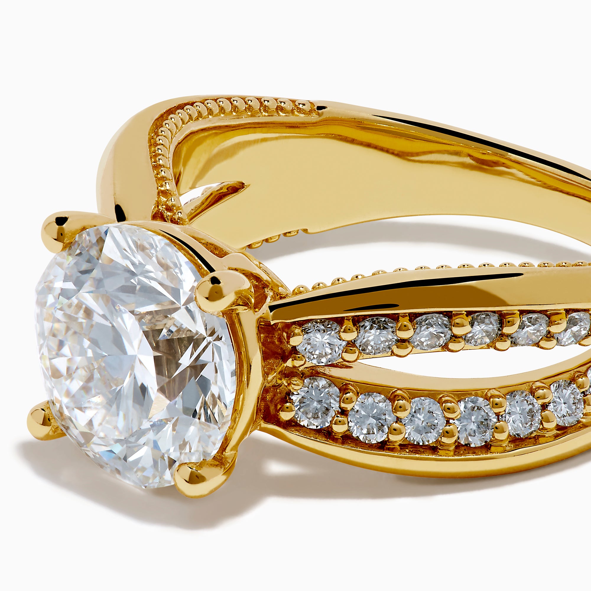 The Star Lab Grown Diamond Embrace Ring in 18K Yellow Gold showcases a prominent round lab-grown diamond center, with rows of smaller diamonds along the band and detailed side designs.