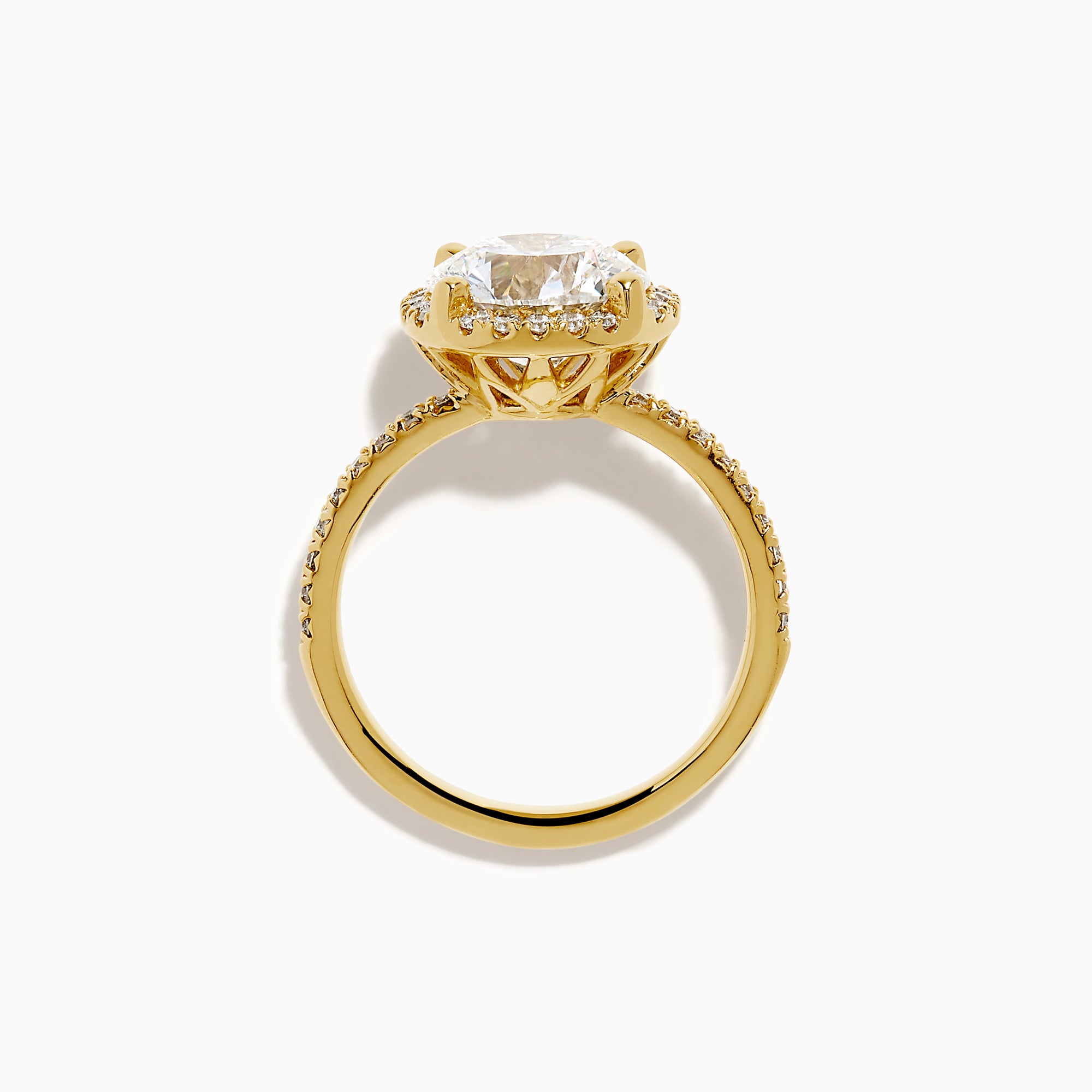 The Star Lab Grown Diamond Halo Ring in 18K Yellow Gold showcases a large oval lab diamond center, encircled by a halo of star lab diamonds and additional diamonds along the band for extra brilliance.