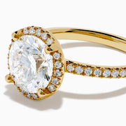 The Star Lab Grown Diamond Halo Ring in 18K Yellow Gold showcases a large oval lab diamond center, encircled by a halo of star lab diamonds and additional diamonds along the band for extra brilliance.