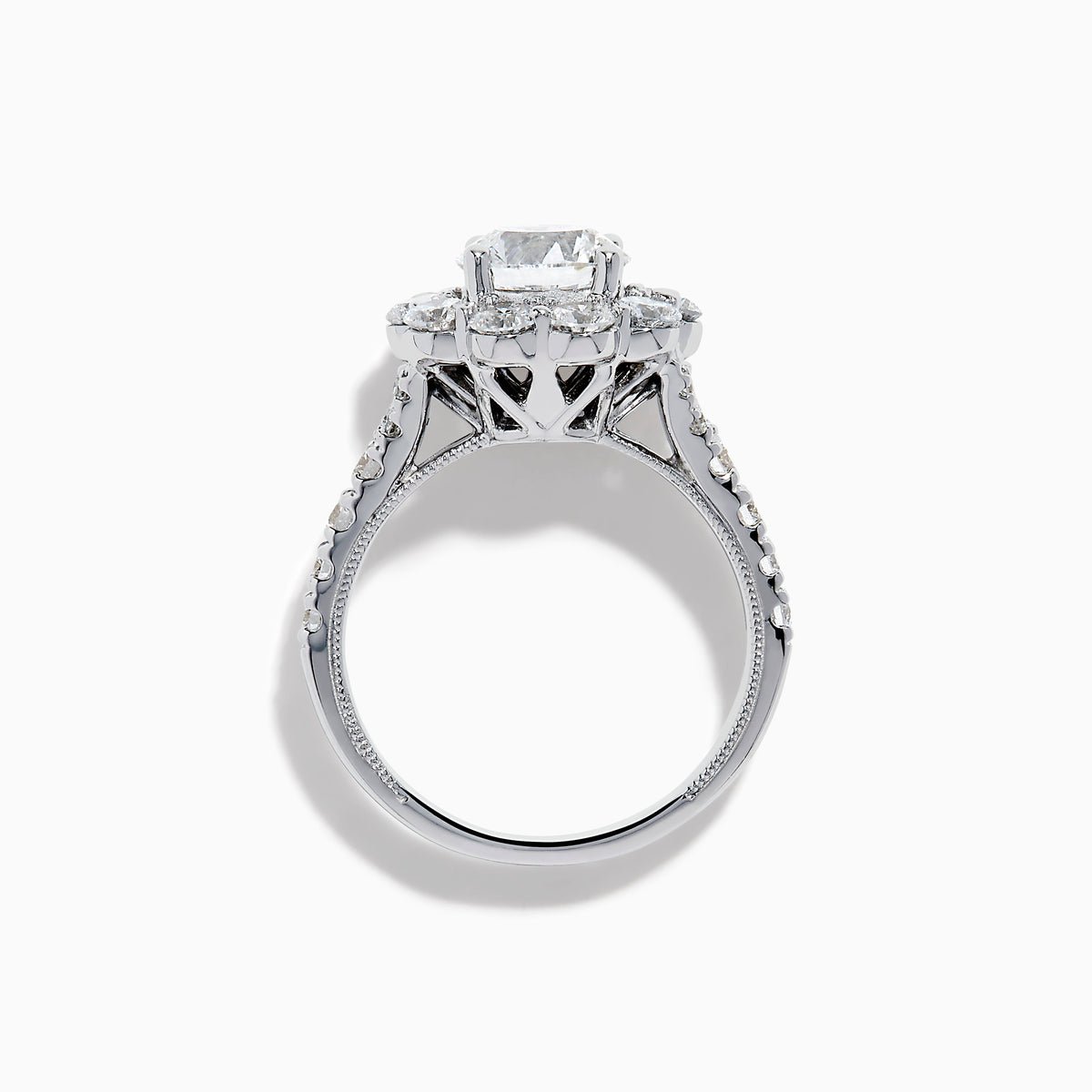 The Star Lab Grown Diamond Fleur Ring in 18K White Gold showcases a large round center lab diamond, with a sparkling halo of smaller diamonds and extra diamonds set along the band.