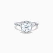The Star Lab Grown Diamond Halo Ring in 18K White Gold features a large round lab diamond center, encircled by a sparkling halo and delicate stones on the band, shown against a white background.