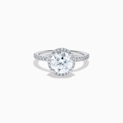 The Star Lab Grown Diamond Halo Ring in 18K White Gold features a large round lab diamond center, encircled by a sparkling halo and delicate stones on the band, shown against a white background.