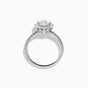 The Star Lab Grown Diamond Halo Ring in 18K White Gold features a large round lab diamond center, encircled by a sparkling halo and delicate stones on the band, shown against a white background.