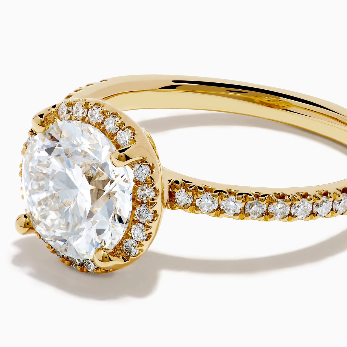 The Star Lab Grown Diamond Halo Ring in 18K Yellow Gold showcases an oval lab-grown diamond center, surrounded by a sparkling diamond halo and accented with diamonds along the band.