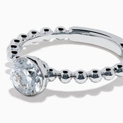 The Star Lab Grown Diamond Solitaire Beaded Ring in 18K White Gold features a round lab diamond center accented by polished beaded details along the band, shown on a white background.