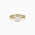 The Star Lab Grown Diamond Moderne Ring in 18K yellow gold features a beaded band and a large round lab diamond at its center, displayed on a white background.