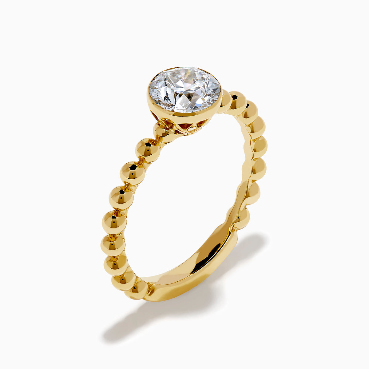 The Star Lab Grown Diamond Moderne Ring in 18K yellow gold features a beaded band and a large round lab diamond at its center, displayed on a white background.