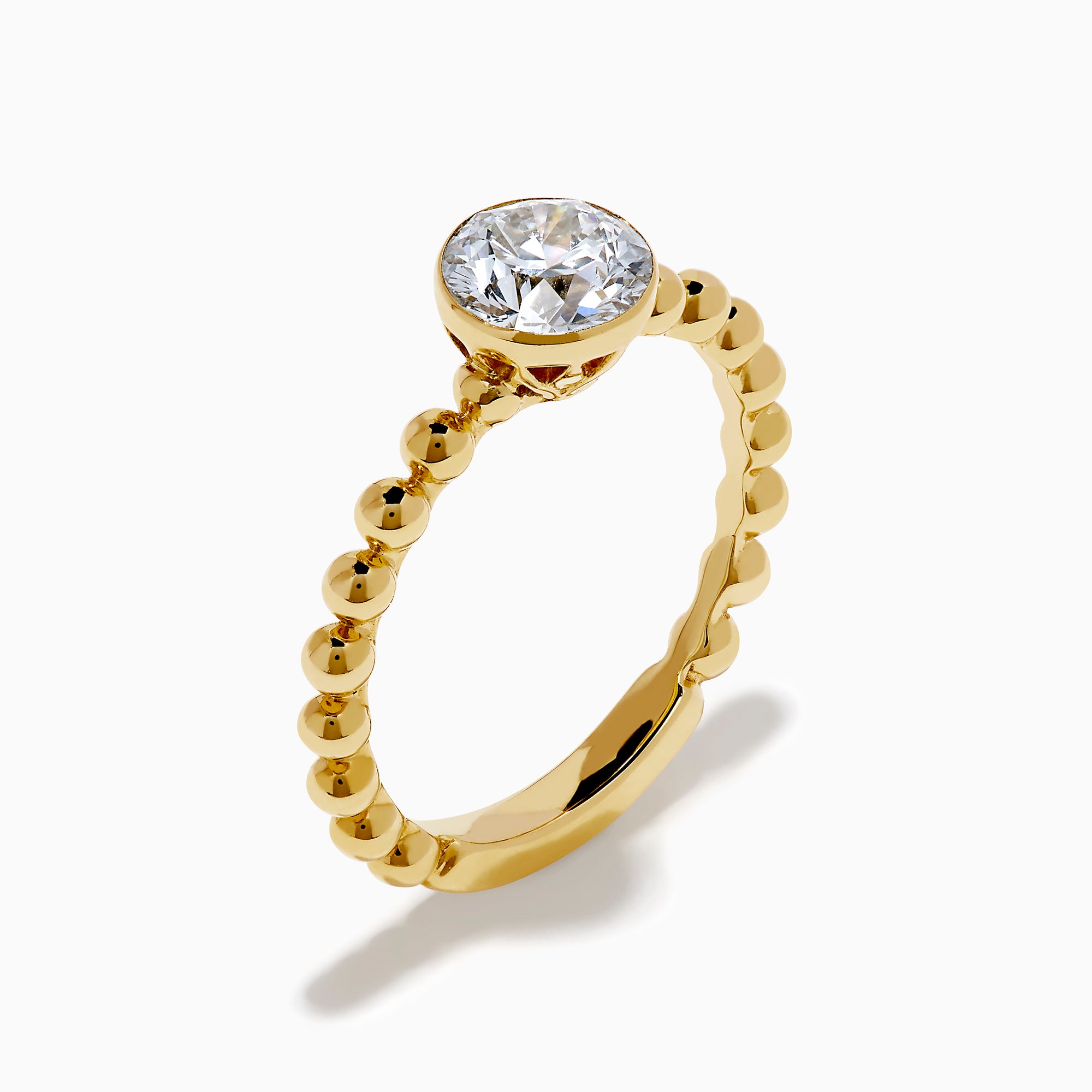 The Star Lab Grown Diamond Moderne Ring in 18K yellow gold features a beaded band and a large round lab diamond at its center, displayed on a white background.