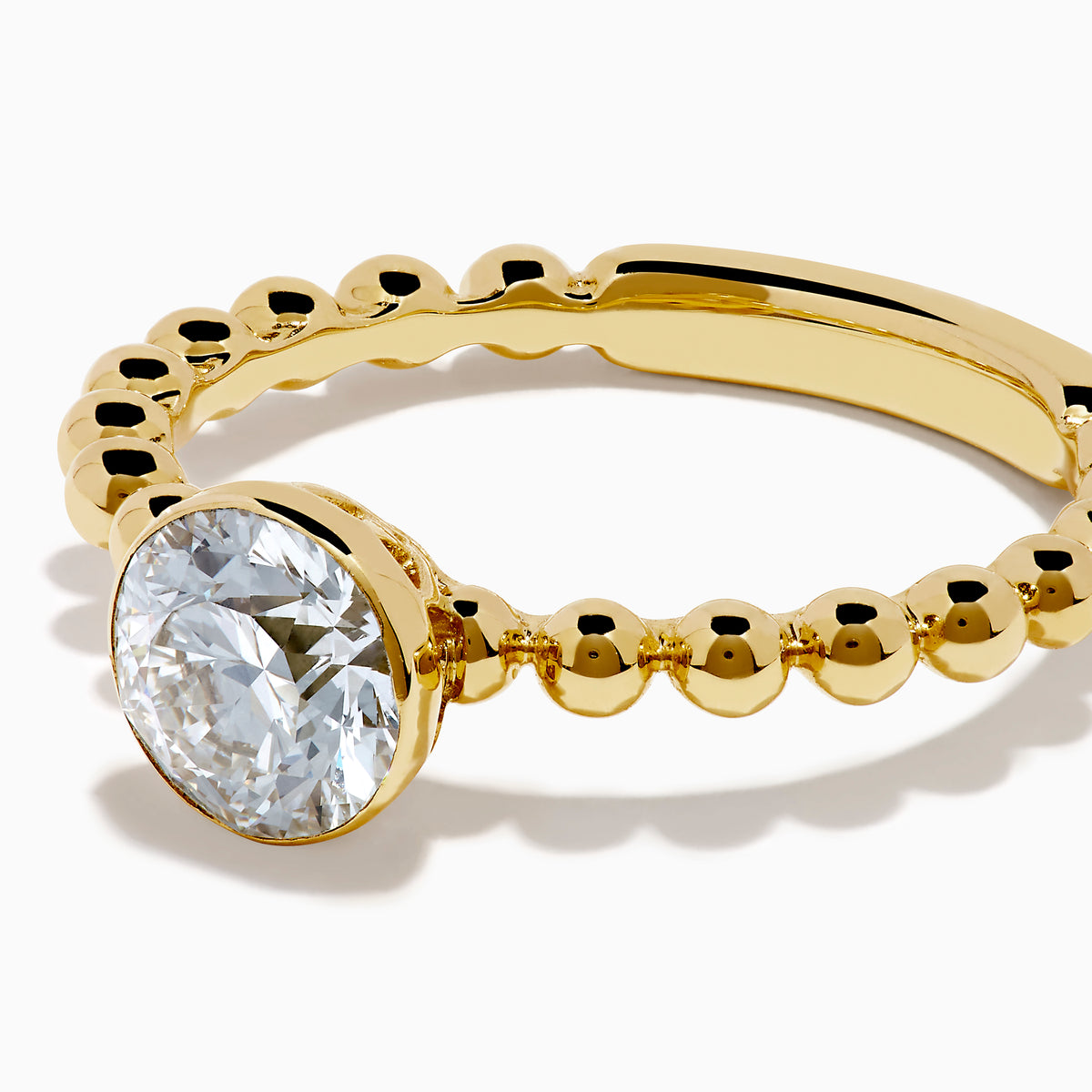 The Star Lab Grown Diamond Moderne Ring in 18K yellow gold features a beaded band and a large round lab diamond at its center, displayed on a white background.
