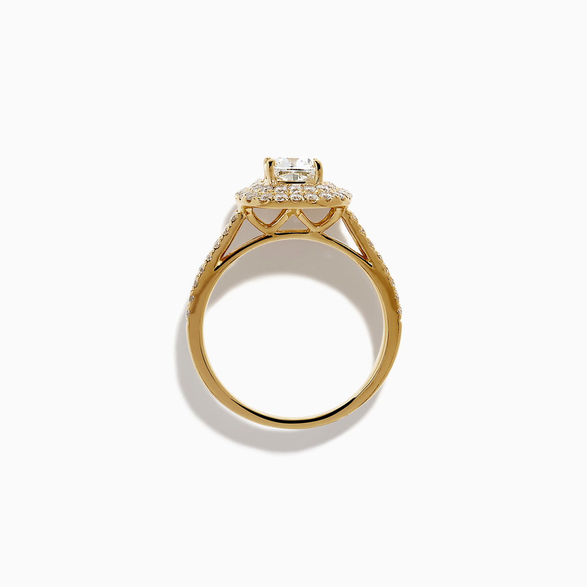 The 18K Yellow Gold Diamond Double Halo Ring showcases a cushion-cut center stone, surrounded by a double halo of round diamonds and additional diamonds set along the split shank band.