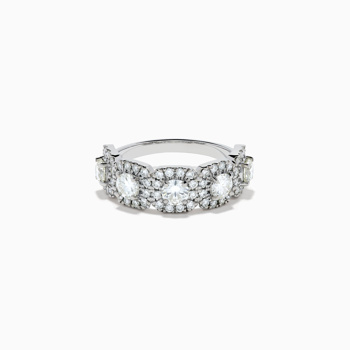 The 18K White Gold Diamond Round Halo Band Ring showcases three central round diamonds, each with a diamond halo, and features rectangular diamond accents on the sides for added brilliance.