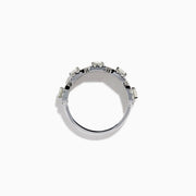 The 18K White Gold Diamond Round Halo Band Ring showcases three central round diamonds, each with a diamond halo, and features rectangular diamond accents on the sides for added brilliance.
