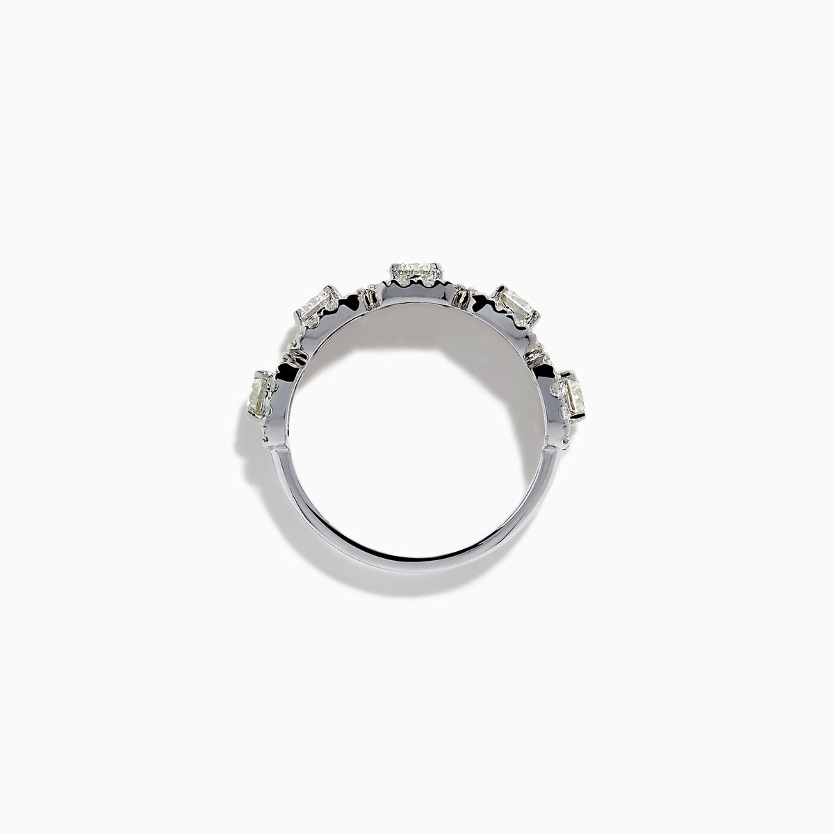 The 18K White Gold Diamond Round Halo Band Ring showcases three central round diamonds, each with a diamond halo, and features rectangular diamond accents on the sides for added brilliance.