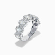The 18K White Gold Diamond Oval Halo Band Ring showcases large oval-cut diamonds, each surrounded by a sparkling halo of smaller stones, elegantly displayed on a white background.