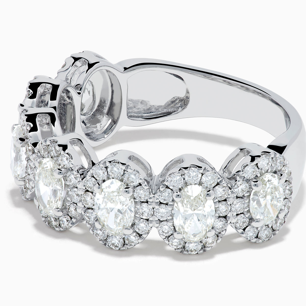 The 18K White Gold Diamond Oval Halo Band Ring showcases large oval-cut diamonds, each surrounded by a sparkling halo of smaller stones, elegantly displayed on a white background.
