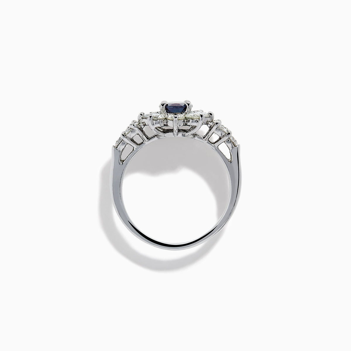 A Platinum GIA Certified Alexandrite and Diamond Starburst Halo Ring, featuring an oval dark blue-green central Alexandrite and sparkling diamond accents, displayed on a white background.