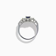 A Platinum GIA Certified Alexandrite and Diamond Starburst Halo Ring, featuring an oval dark blue-green central Alexandrite and sparkling diamond accents, displayed on a white background.