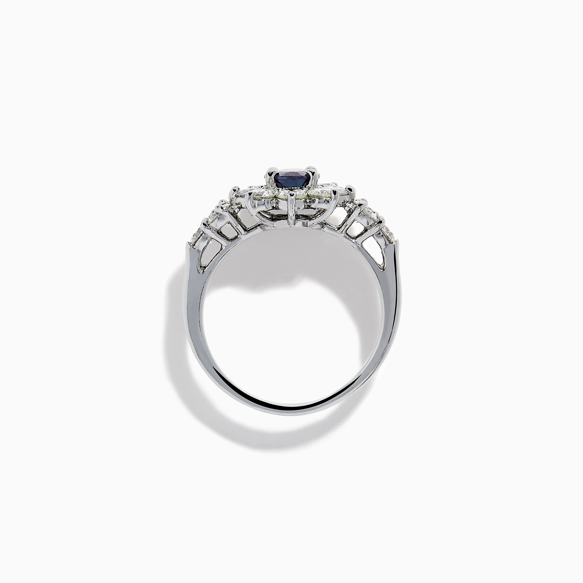 A Platinum GIA Certified Alexandrite and Diamond Starburst Halo Ring, featuring an oval dark blue-green central Alexandrite and sparkling diamond accents, displayed on a white background.