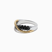 The 14K Two-Tone Gold Black and White Diamond Crossover Ring showcases two rows of black diamonds crossed diagonally by a wavy line of white stones set in gold.