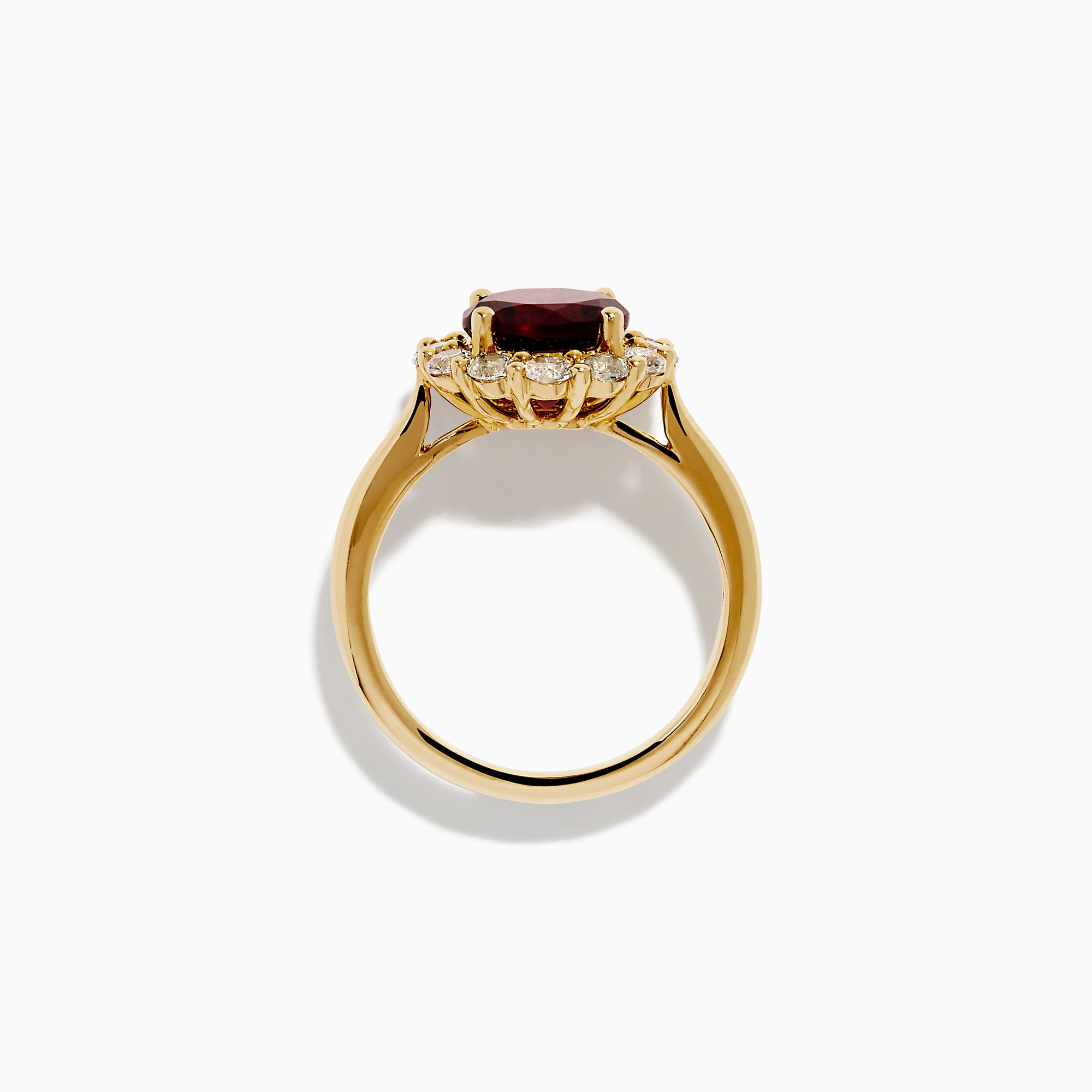 The 14K Yellow Gold Garnet and White Sapphire Halo Ring showcases a vibrant round garnet center, surrounded by sparkling white sapphires, set in yellow gold and displayed on a white background.