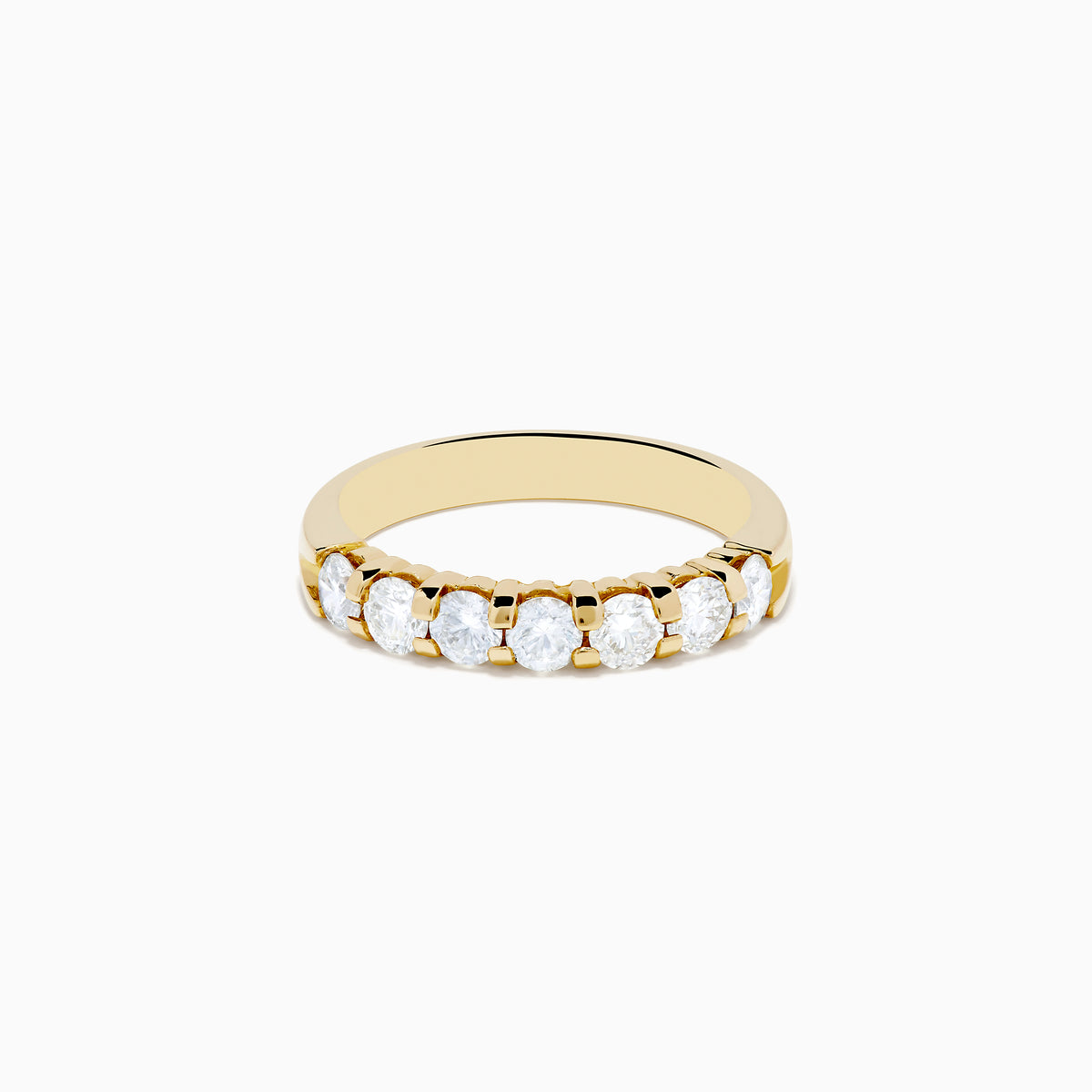 The 14K Yellow Gold 7-Stone Prong Set Diamond Band showcases a row of seven oval-cut white diamonds, totaling 1.00 TCW, displayed on a plain white background.