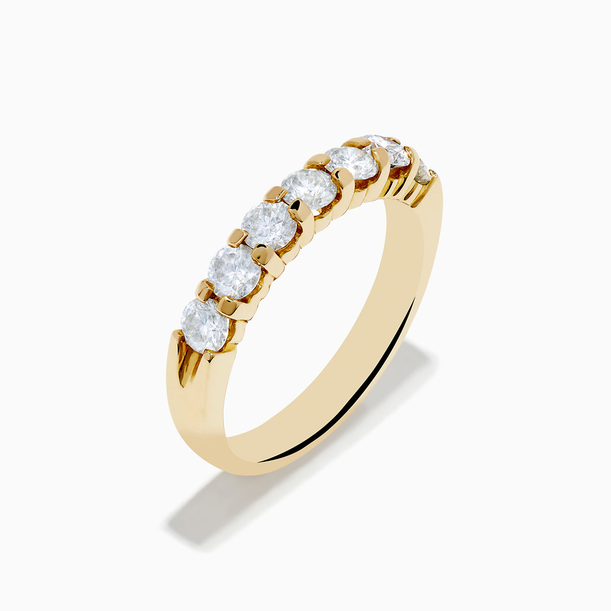 The 14K Yellow Gold 7-Stone Prong Set Diamond Band showcases a row of seven oval-cut white diamonds, totaling 1.00 TCW, displayed on a plain white background.
