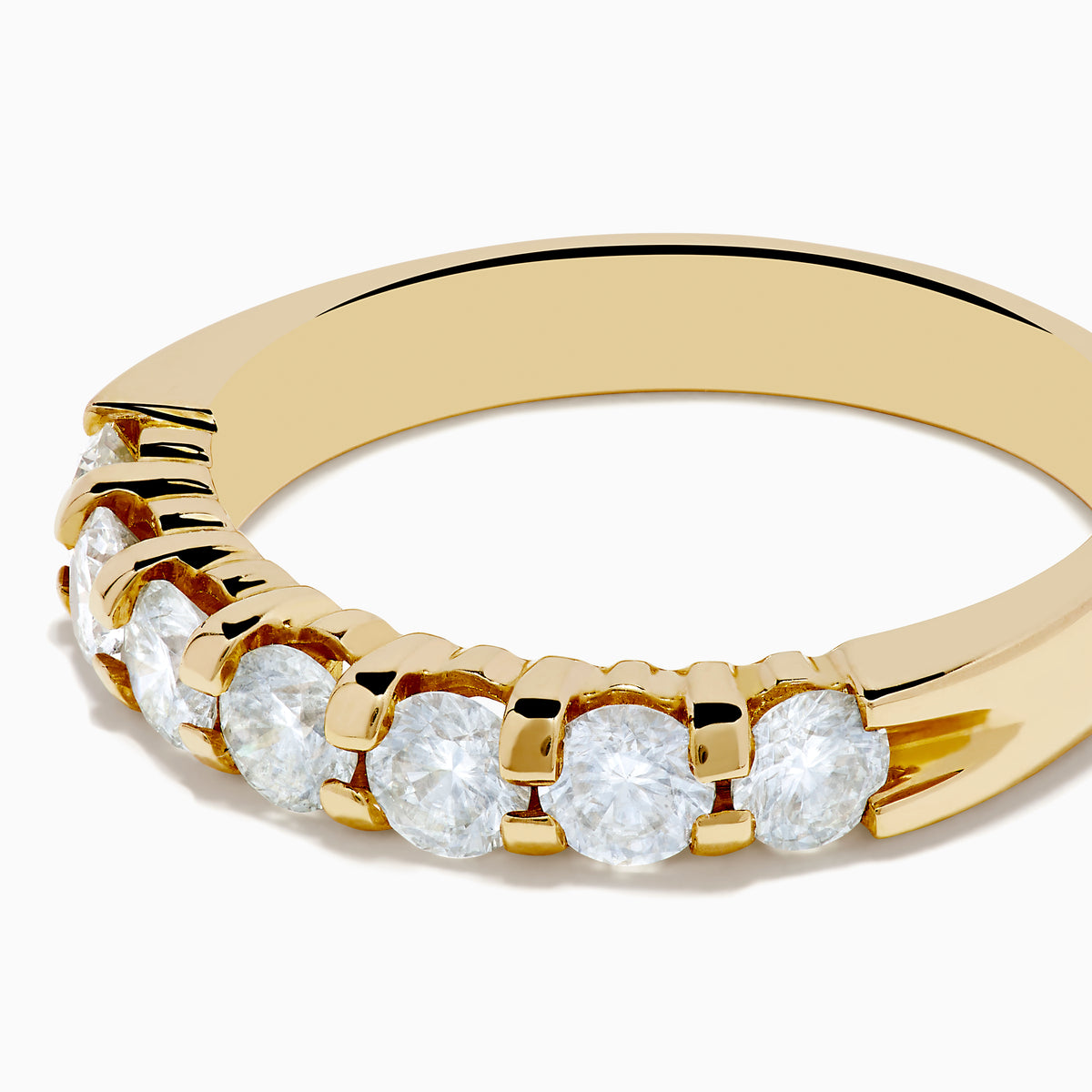 The 14K Yellow Gold 7-Stone Prong Set Diamond Band showcases a row of seven oval-cut white diamonds, totaling 1.00 TCW, displayed on a plain white background.