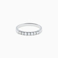 The 14K White Gold 7-Stone Prong Set Diamond Band, 0.25 TCW, showcases a row of seven round diamonds in prong settings across the top, shown on a plain white background.