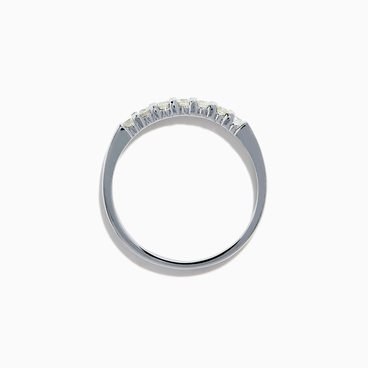 The 14K White Gold 7-Stone Prong Set Diamond Band, 0.25 TCW, showcases a row of seven round diamonds in prong settings across the top, shown on a plain white background.