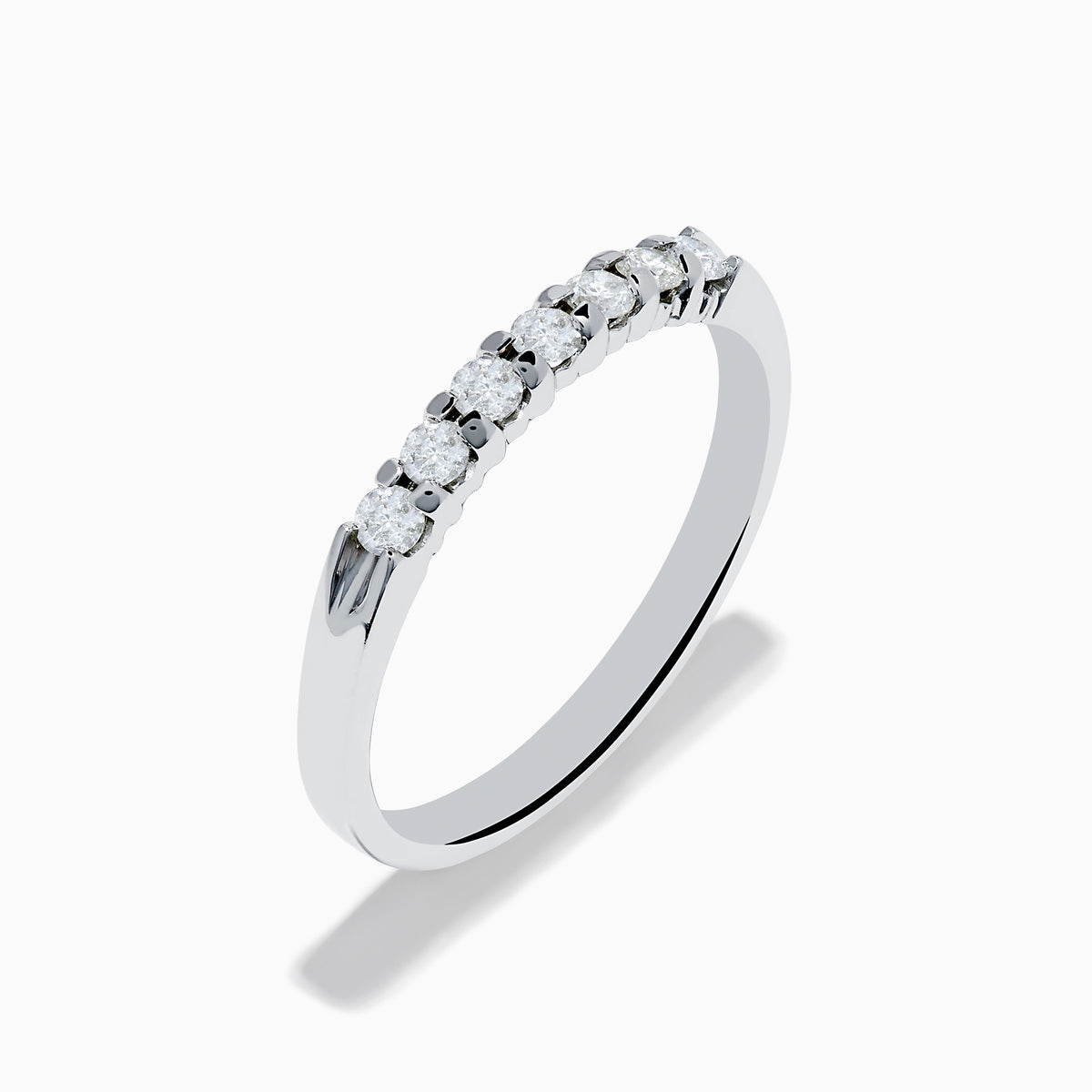 The 14K White Gold 7-Stone Prong Set Diamond Band, 0.25 TCW, showcases a row of seven round diamonds in prong settings across the top, shown on a plain white background.