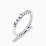 The 14K White Gold 7-Stone Prong Set Diamond Band, 0.25 TCW, showcases a row of seven round diamonds in prong settings across the top, shown on a plain white background.