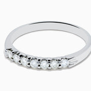 The 14K White Gold 7-Stone Prong Set Diamond Band, 0.25 TCW, showcases a row of seven round diamonds in prong settings across the top, shown on a plain white background.