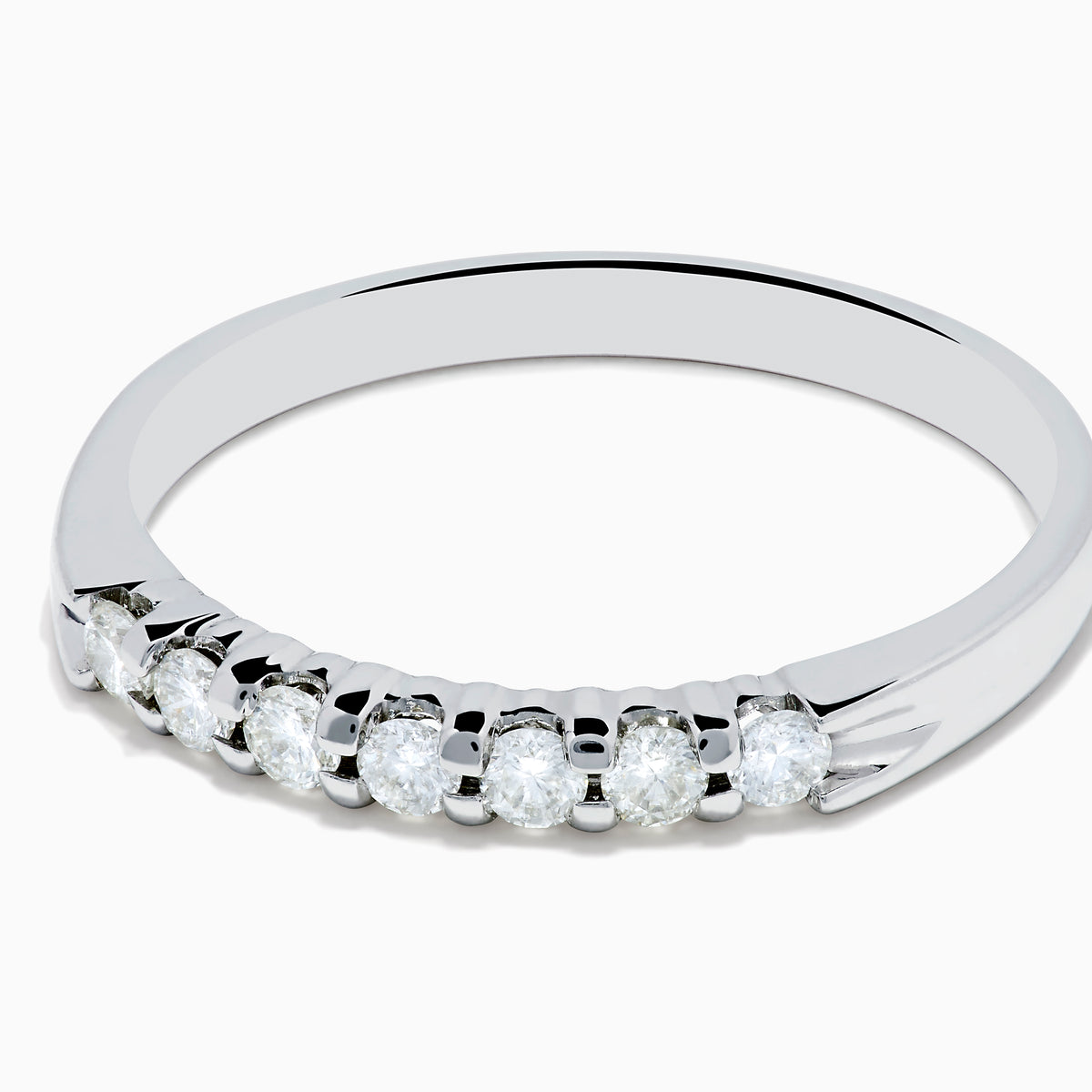 The 14K White Gold 7-Stone Prong Set Diamond Band, 0.25 TCW, showcases a row of seven round diamonds in prong settings across the top, shown on a plain white background.