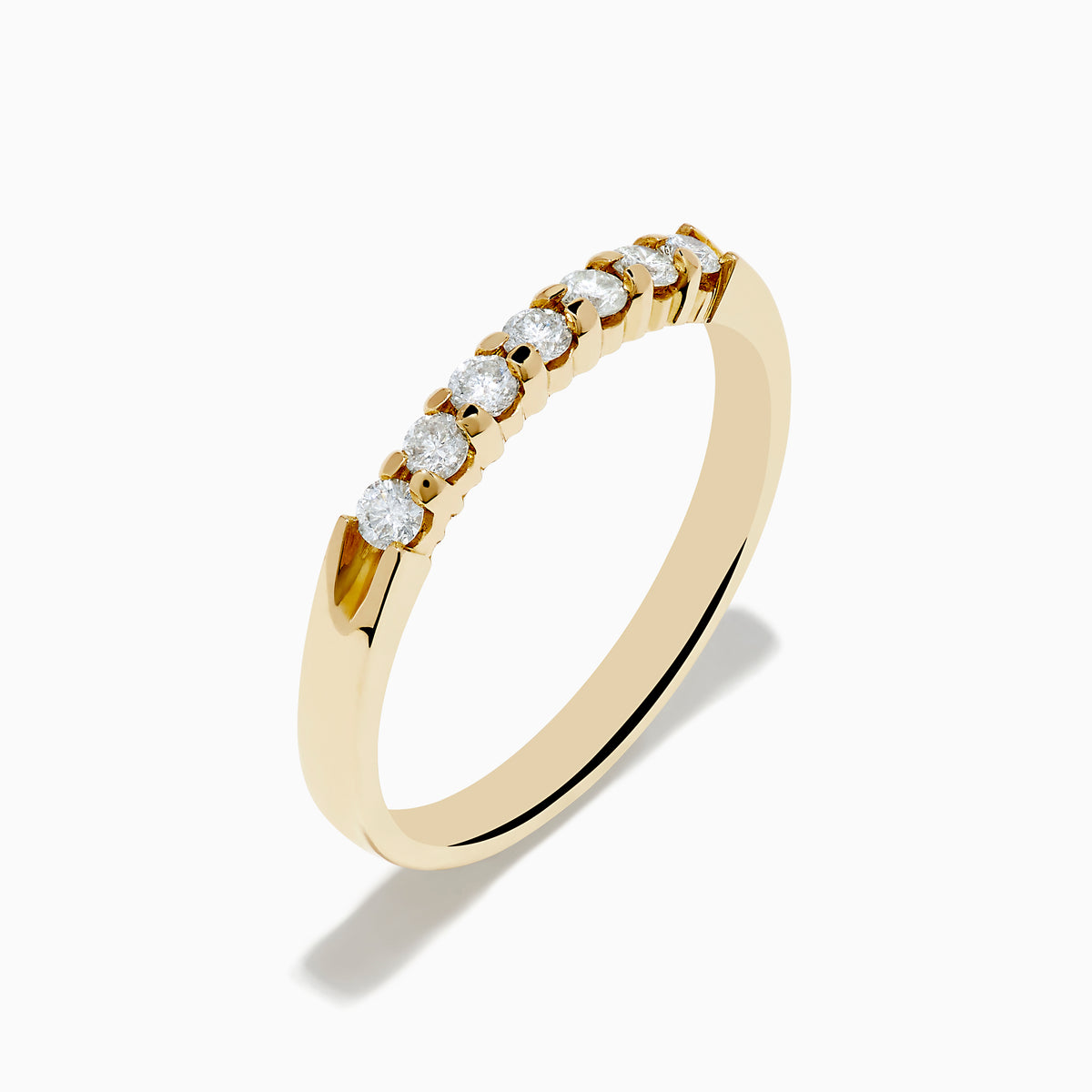 The 14K Yellow Gold 7-Stone Prong Set Diamond Band, 0.25 TCW, showcases a classic row of round white diamonds on a plain white background.