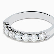 The 14K White Gold 7-Stone Prong Set Diamond Band, 0.75 TCW, showcases seven round diamonds set in a row along the band, displayed on a plain white background.