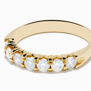 The 14K Yellow Gold 7-Stone Prong Set Diamond Band, 0.75 TCW, showcases a row of seven round diamonds set in yellow gold and displayed against a plain white background.