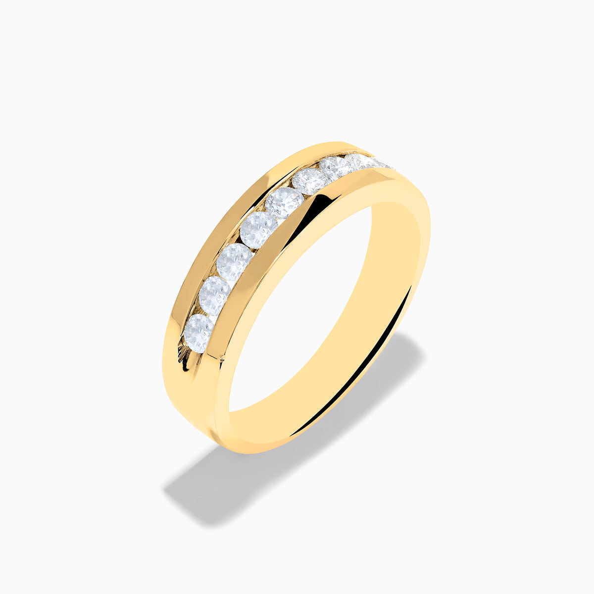 The Mens 14K Yellow Gold 9-Stone Channel Set Diamond Band, 0.75 TCW, showcases nine round diamonds in a horizontal channel across the front, displayed on a plain white background.