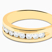 The Mens 14K Yellow Gold 9-Stone Channel Set Diamond Band, 0.75 TCW, showcases nine round diamonds in a horizontal channel across the front, displayed on a plain white background.